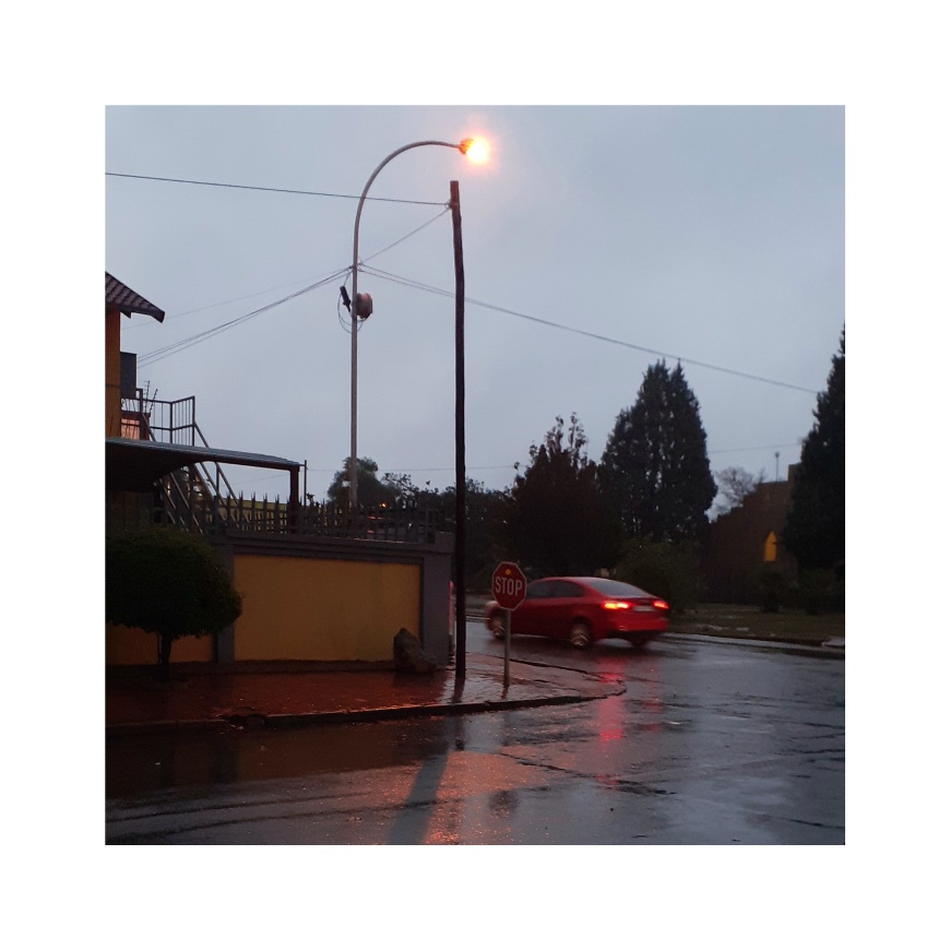 A car driving past a traffic sign.