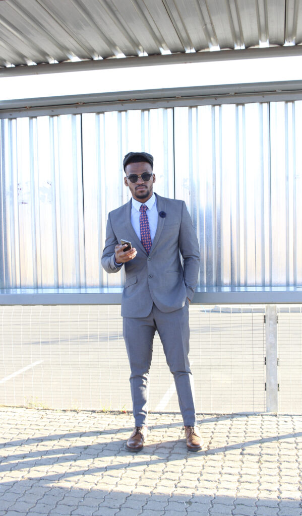 A photo of a man posing in a smart suit.