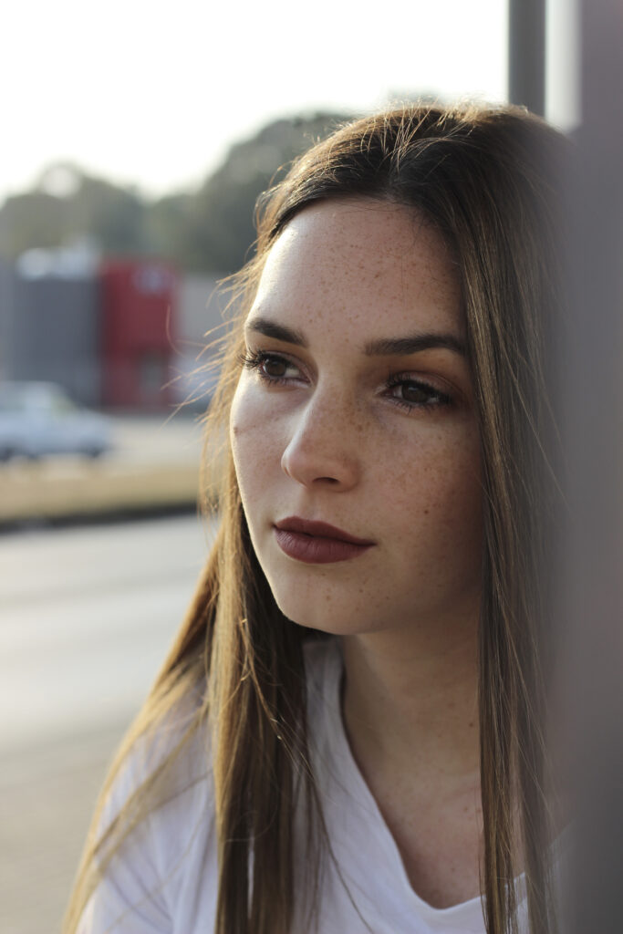 A photo of a woman posing at a bus stop in the West Rand of Gauteng.