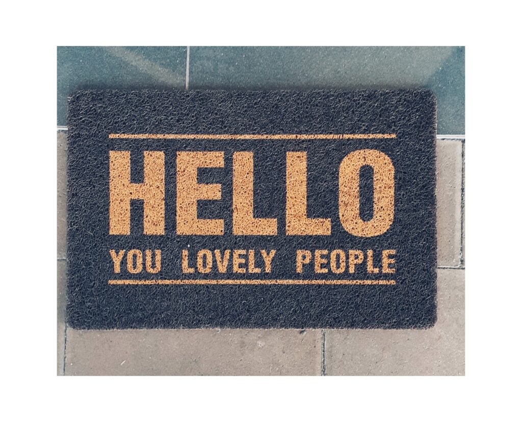 A doormat with the words Hello You Lovely People printed on it.