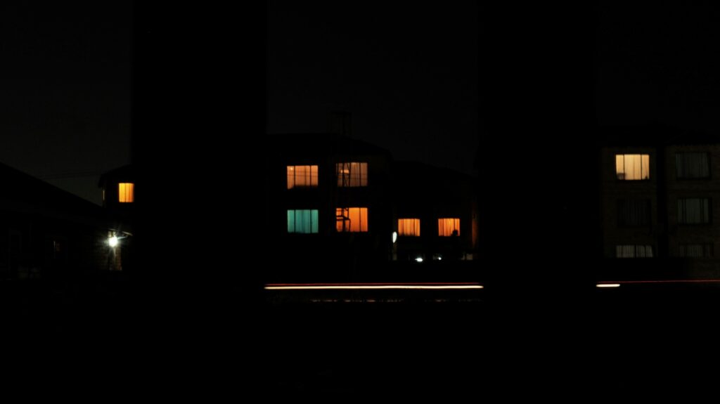 A blurry image of an apartment complex taken at night.