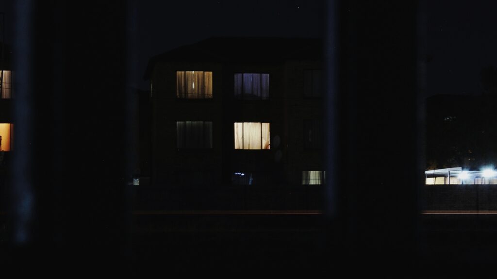 An apartment building at night.