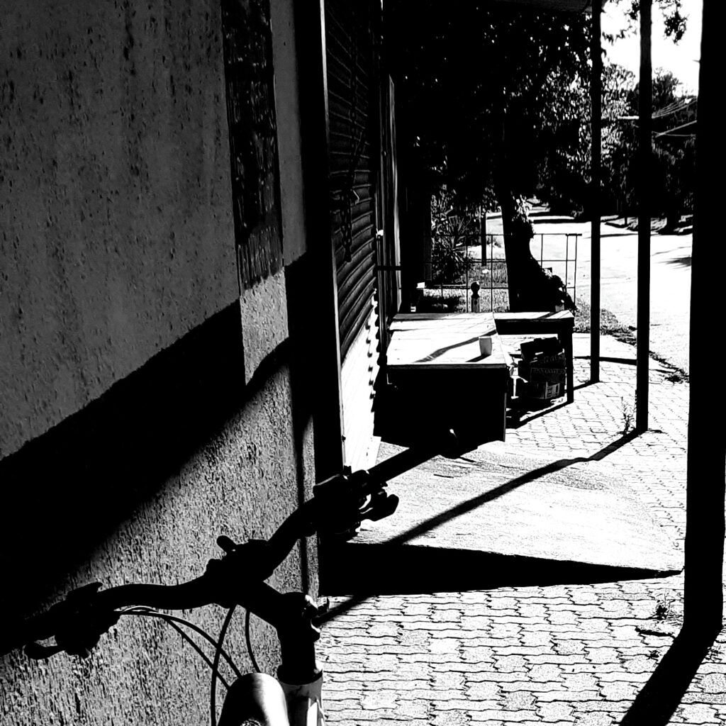 An empty cup standing outside a closed business.