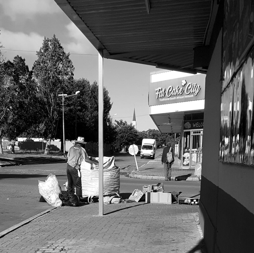 A man collecting boxes to be recycled.