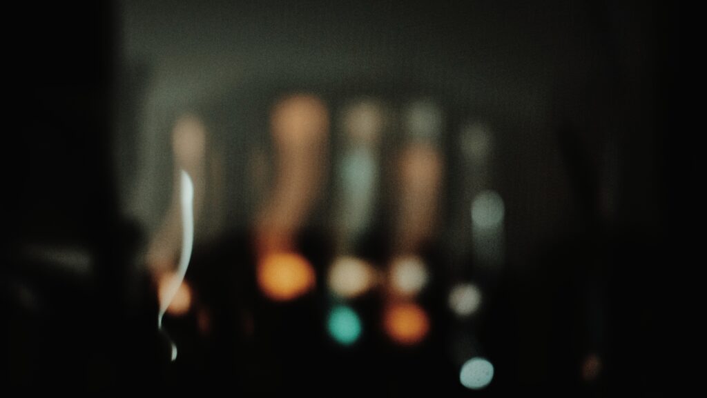 A group of lights which are out of focus and suffers from motion blur.