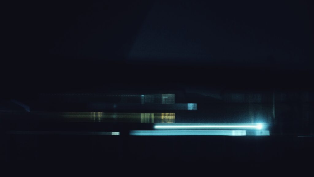 A photograph of a block of apartments at night time.